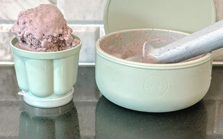 Mint green Catchy bowls with chocolate ice cream, ideal for mess-free mealtime on kitchen counter.
